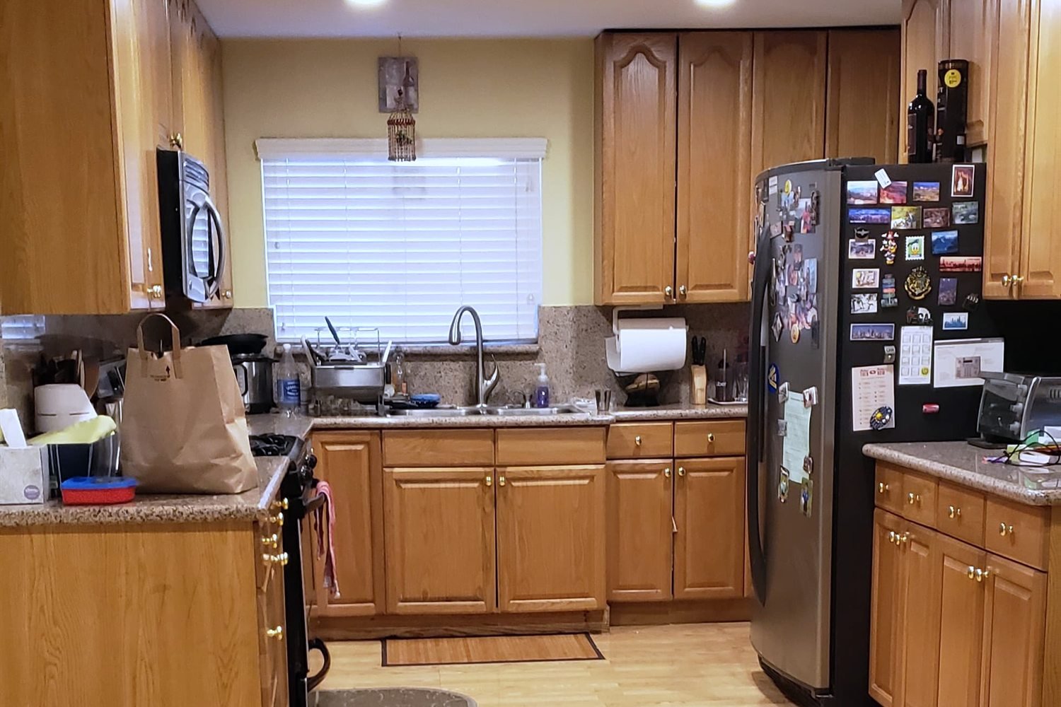 Kitchen before renovation — closed galley with oak cabinets