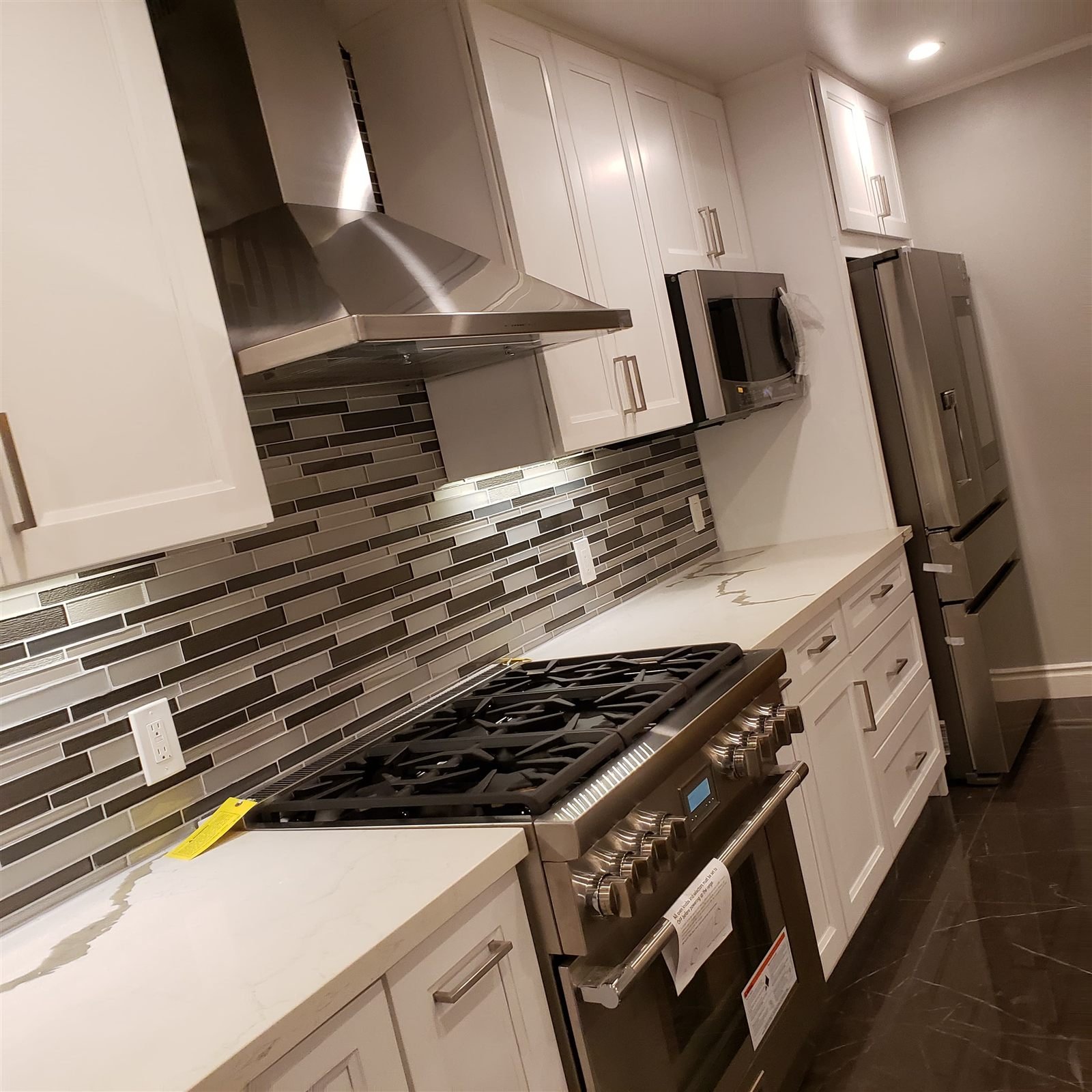 Kitchen with tile backsplash and stainless range