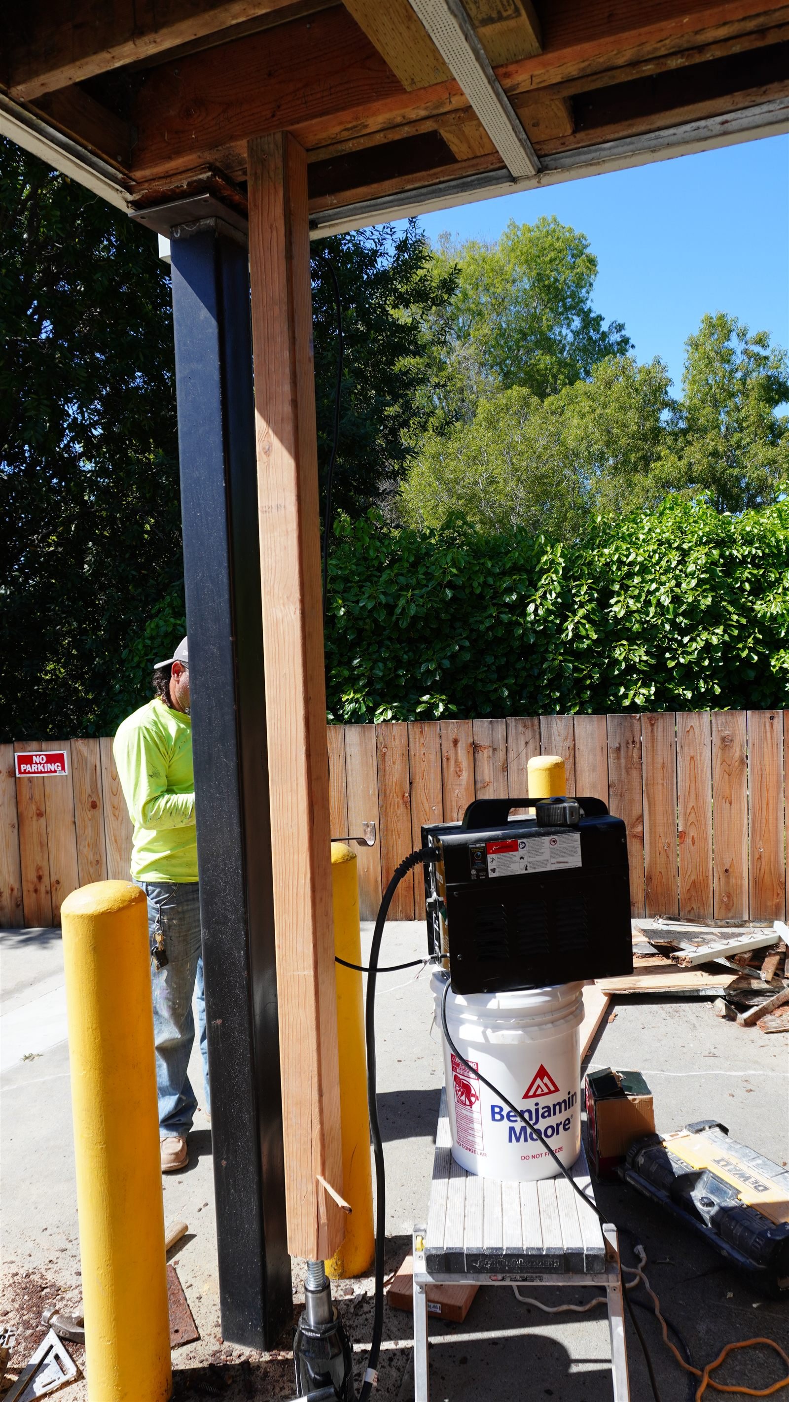 Crew setting a steel post with temporary shoring