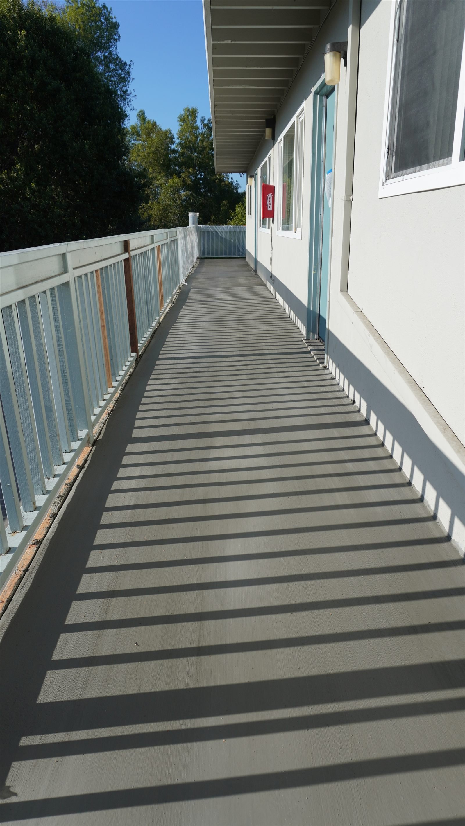 Resurfaced multi-family walkway after structural repair