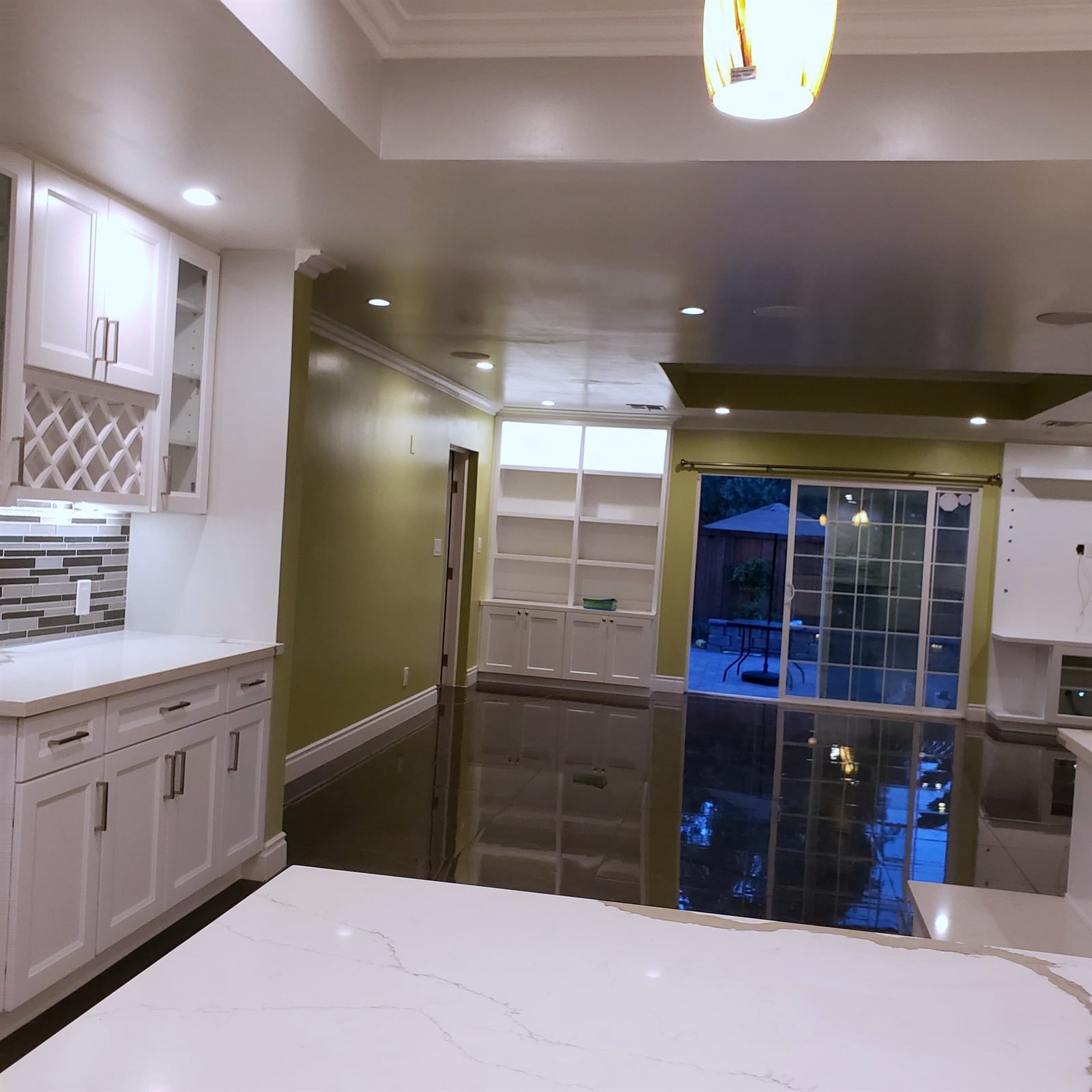 Open kitchen with quartz waterfall island